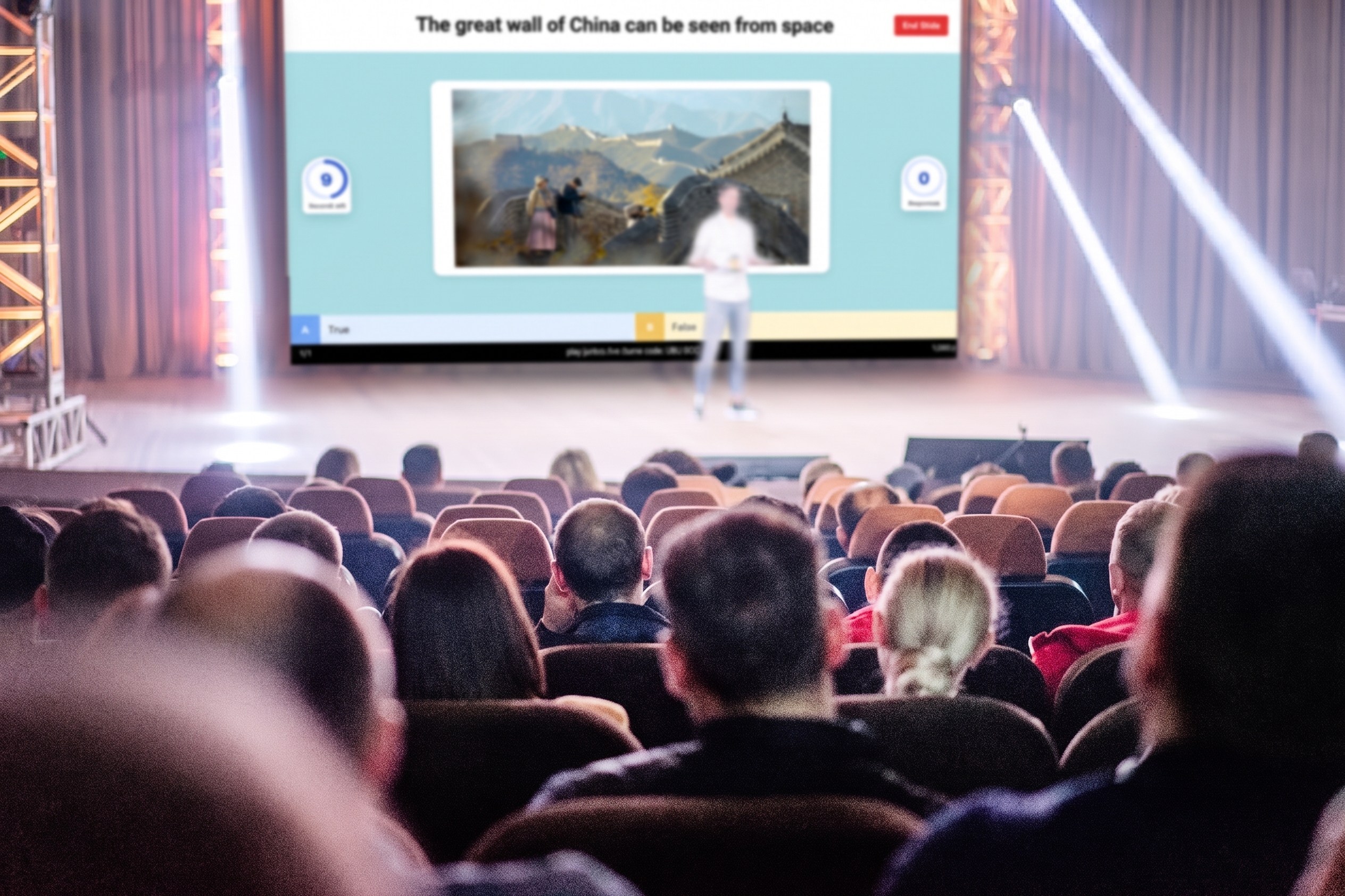 Audience watching a Juntos quiz presentation on stage